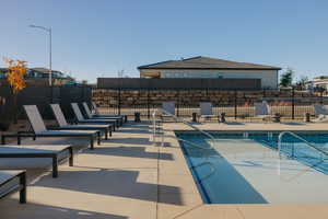 Community pool with a patio