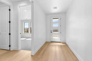 Entryway featuring wood finished floors and baseboards