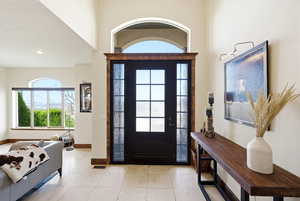 Foyer entrance featuring light tile patterned flooring and baseboards