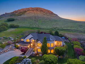 View of front of property with driveway, stucco siding, a garage, and a metal roof