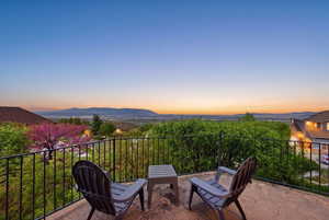 Balcony at dusk featuring a mountain view