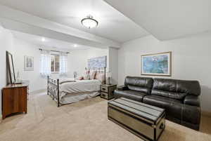 4th bedroom with light carpet with seating area