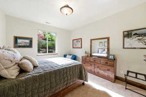 2nd Bedroom featuring light colored carpet and wood baseboards
