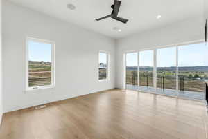 Unfurnished room with ceiling fan, plenty of natural light, recessed lighting, and light wood-style flooring