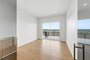 Spare room featuring recessed lighting, light wood-type flooring, and a mountain view
