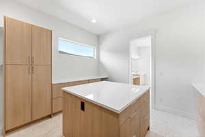 Walk in closet with light tile patterned floors