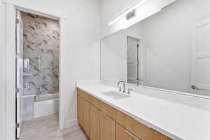 Full bath with vanity and shower / bath combination with glass door