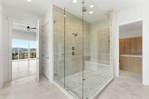 Bathroom featuring a shower stall, recessed lighting, and a spacious closet