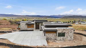 View of front of property featuring a mountain view and stone siding