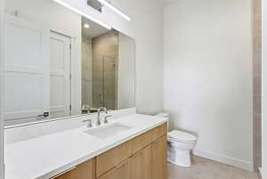 Bathroom with vanity, a shower stall, and light tile patterned floors