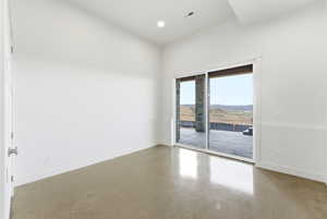 Empty room with concrete flooring and recessed lighting
