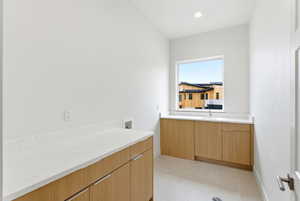 Bathroom featuring vanity, recessed lighting, and light tile patterned floors