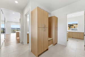 Hall with recessed lighting and baseboards