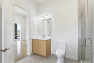 Bathroom featuring a shower stall and vanity
