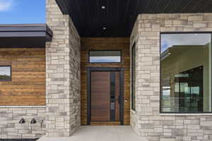 Entrance to property with stone siding