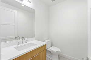 Half bathroom featuring vanity and light tile patterned floors