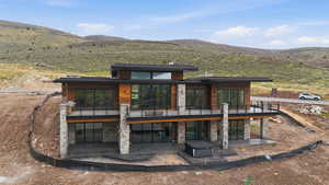 Rear view of property with a patio and a mountain view