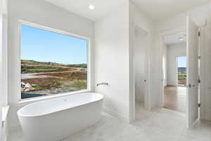 Bathroom featuring a freestanding bath and recessed lighting