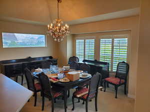 Dining room with light carpet and hanging lights