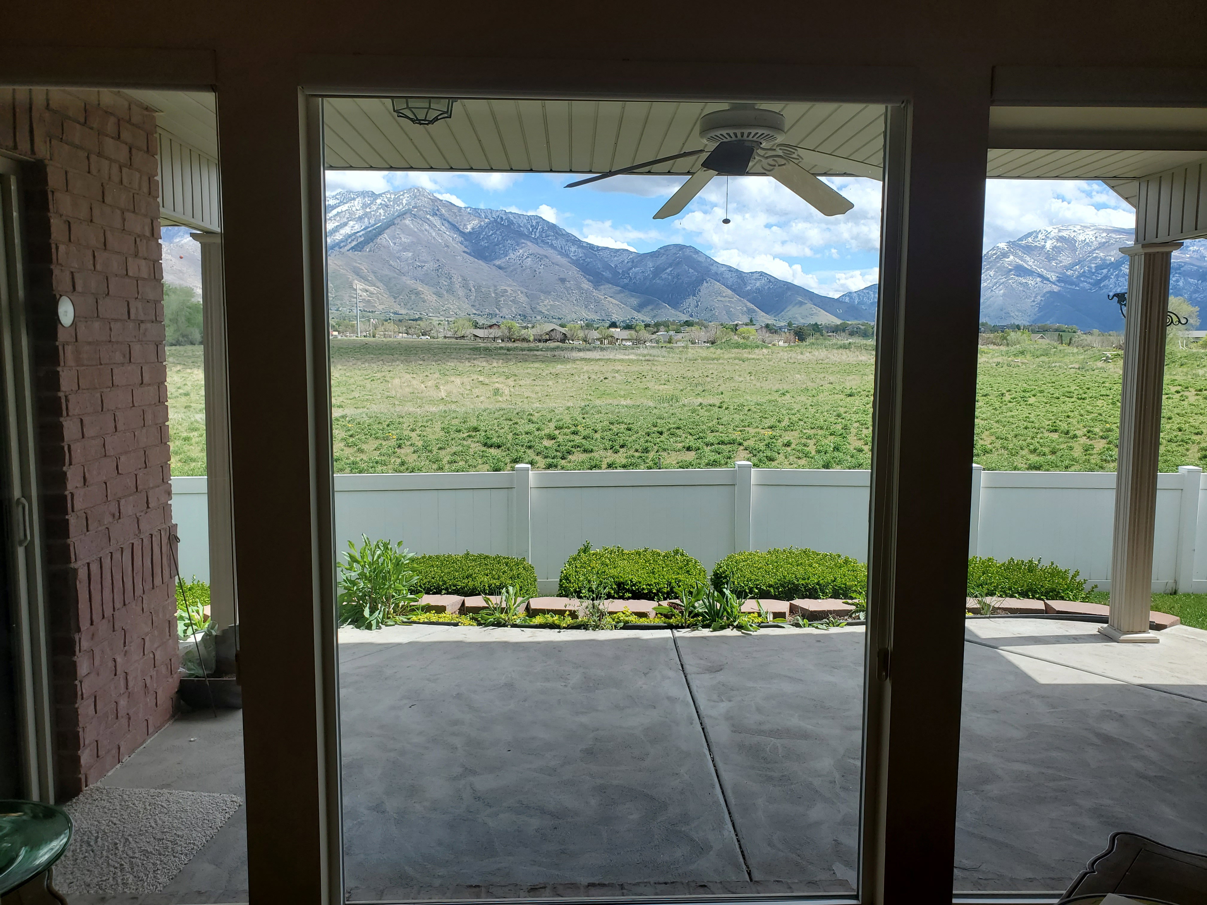 Doorway to outside featuring a mountain view and ceiling fan