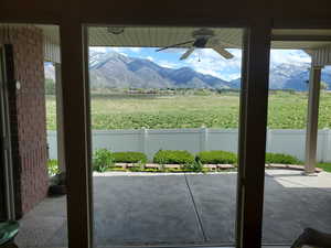 Doorway to outside featuring a mountain view and ceiling fan