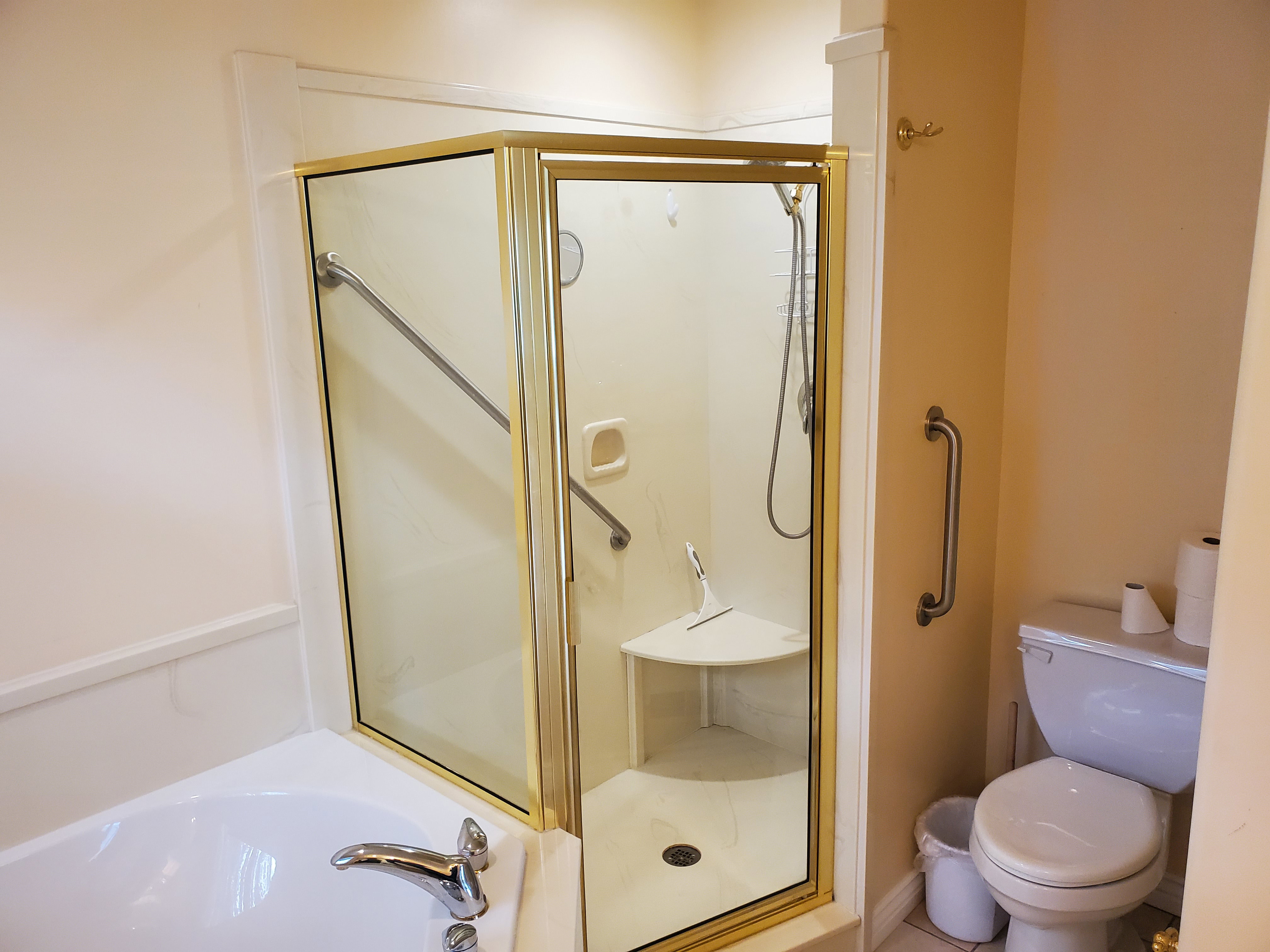 Bathroom with a stall shower and a garden tub