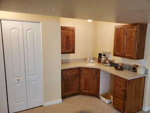Kitchen featuring light countertops and wood finish cabinets