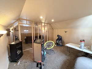 Bonus room featuring a textured ceiling and carpet