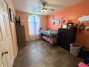 Bedroom featuring a closet, a textured ceiling, and a ceiling fan