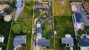 Aerial view of residential area featuring property boundaries highlighted