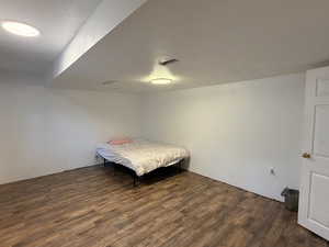 Bedroom featuring dark wood-type flooring