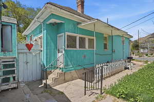 View of side of home featuring a chimney