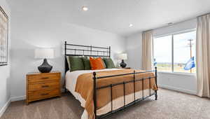 Bedroom with carpet flooring, recessed lighting, and a textured ceiling