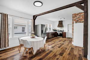 Dining area with dark wood-type flooring and baseboards