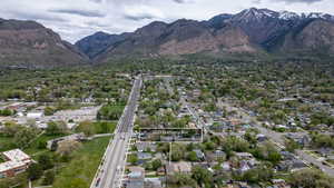 Aerial view of residential area featuring property parcel outlined and a mountain backdrop