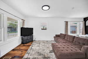 Living area with wood finished floors and baseboards