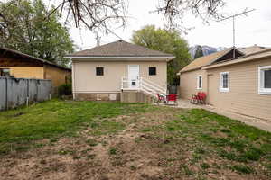 Back of house featuring a patio and a shingled roof