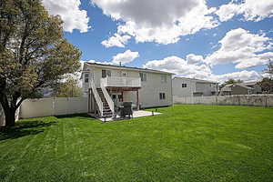 Back of house with a patio, a fenced backyard, and a large, beautiful deck.