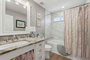 ADU Full bathroom with vanity, shower / bath combo, and light wood-style flooring