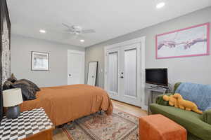 ADU Bedroom featuring light wood-style flooring, ceiling fan, recessed lighting, french doors to the balcony