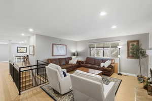 Living room featuring light wood-type flooring and recessed lighting