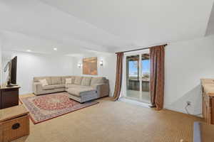 Living room featuring light colored carpet and recessed lighting