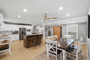 Dining space with ceiling fan, recessed lighting, and light wood finished floors