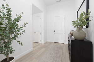 Hall featuring light wood-style floors