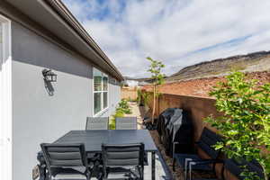 Fenced backyard featuring a patio, a grill, and outdoor dining area
