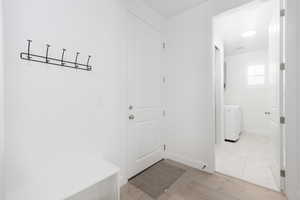 Mudroom featuring light wood finished floors and washer / clothes dryer