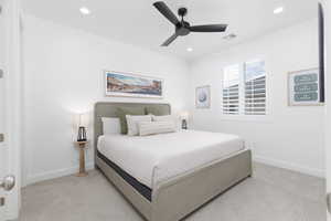Bedroom featuring light colored carpet, a ceiling fan, and recessed lighting