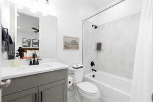 Full bath with vanity, shower / tub combo, and connected bathroom