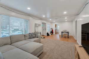 Living room has large windows and plenty of room for seating