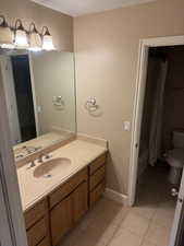 Bathroom featuring vanity, light tile patterned floors, and shower / bath combo